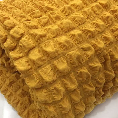 Copridivano elasticizzato con tessuto bolle oro